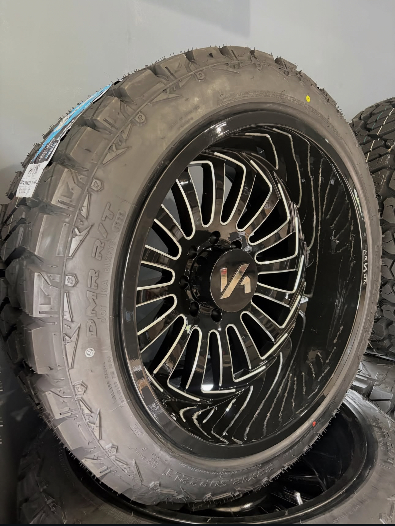Black milled 24-inch wheel and off-road tire